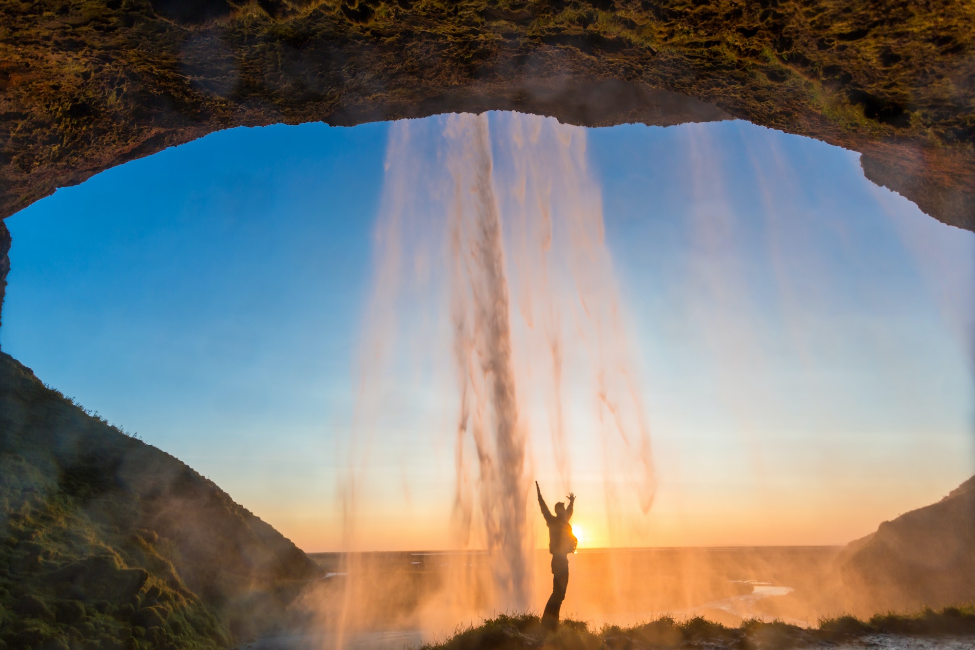 Man behind Seljalandsfoss Waterfall, South Iceland, Iceland